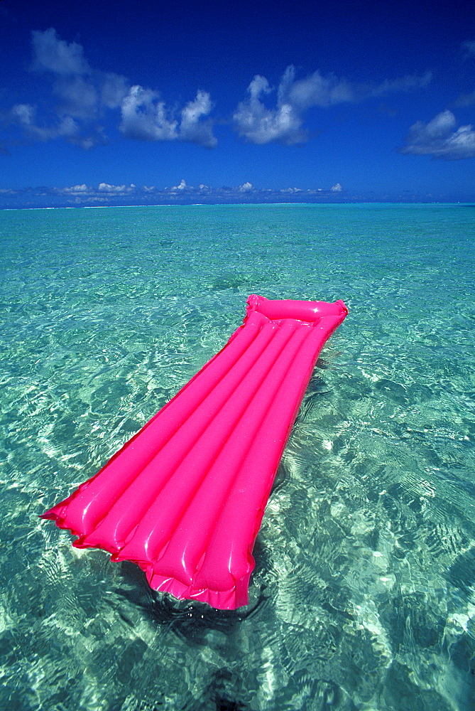 French Polynesia, Bora Bora, Pink inflated raft on clear ocean water seen from Bora Bora lagoon.