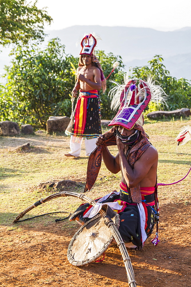 Manggarai men wearing traditional headdress wrapped with cloth and wielding shields and bamboo whips before a caci, a ritual whip fight, Melo village, Flores, East Nusa Tenggara, Indonesia