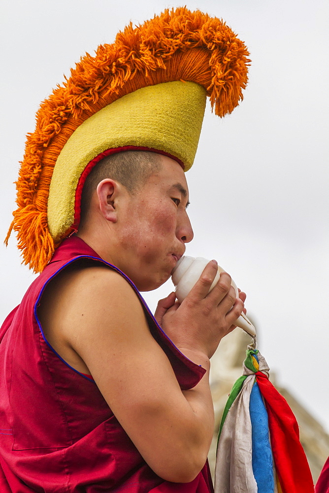 Buddhist monk blowing a conch shell by the Larviran Temple at the Erdene Zuu Monastery, Karakorum (Kharkhorin), Ã–vÃ¶rkhangai Province, Mongolia