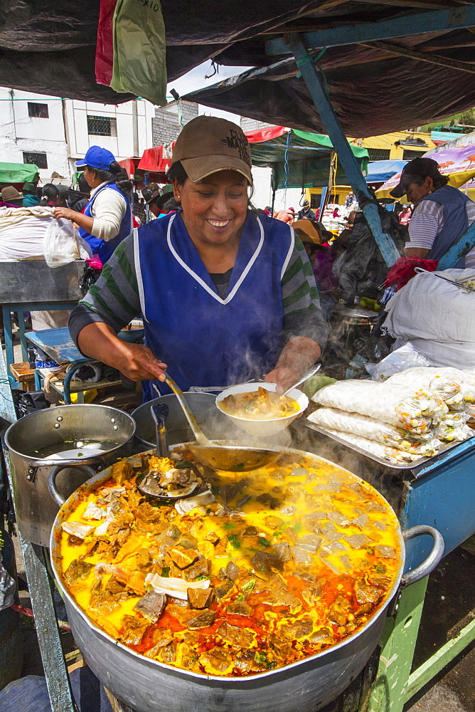 Woman serving food at an eatery at the Thursday market, Guamote, Chimborazo, Ecuador