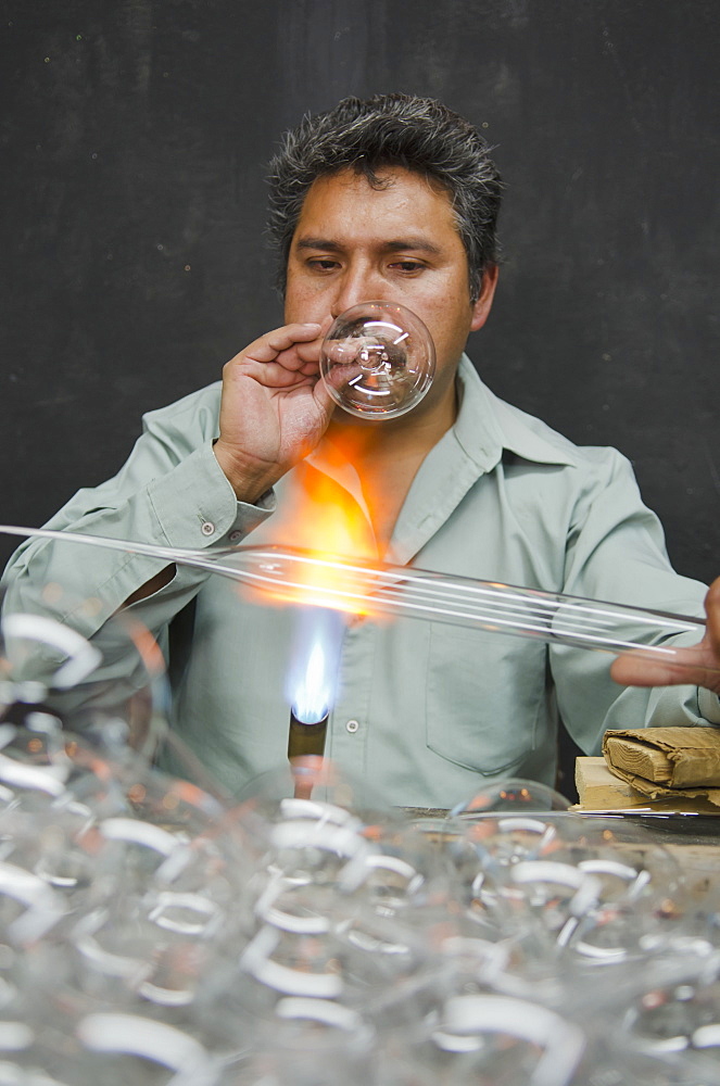 Man blowing and shaping glass, Tlalpujahua, Michoacan, Mexico