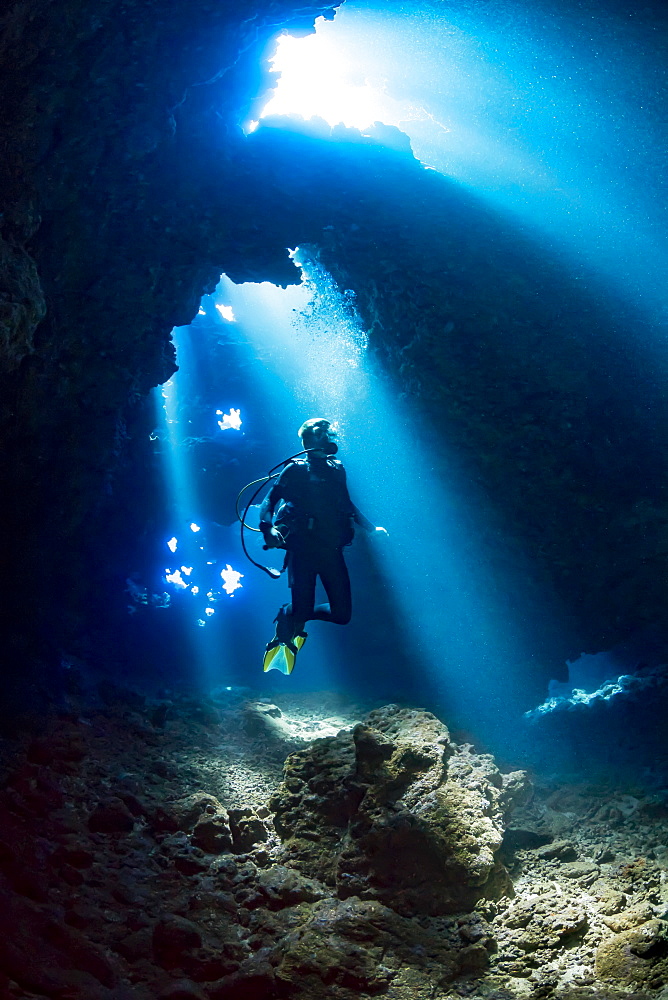 Diver inside a cavern known as First Cathedral off the island of Lanai, Hawaii, United States of America