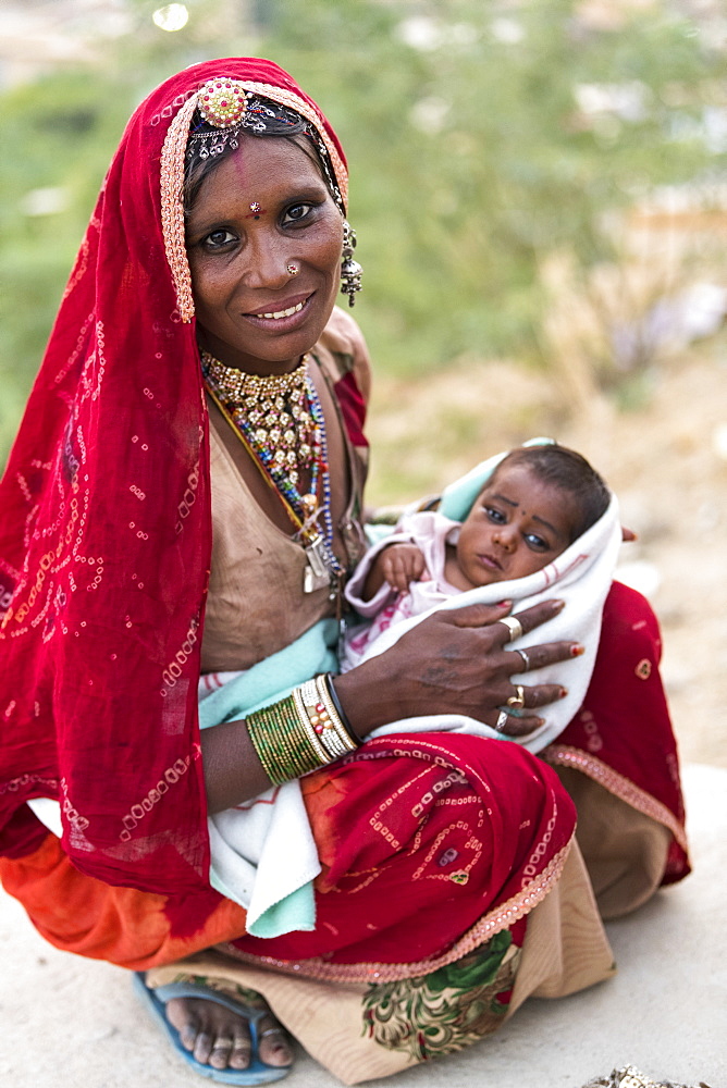 A mother holding her baby girl, Jaisalmer, Rajasthan, India