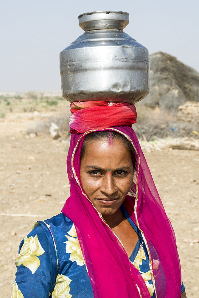 A woman carrying a jug on her head, Jaisalmer, Rajasthan, India