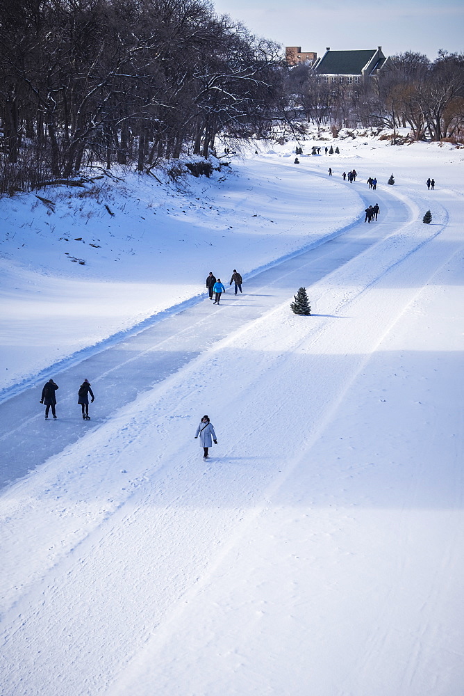 People walking and skating along the Red River Mutual Trail, Winnipeg, Manitoba, Canada