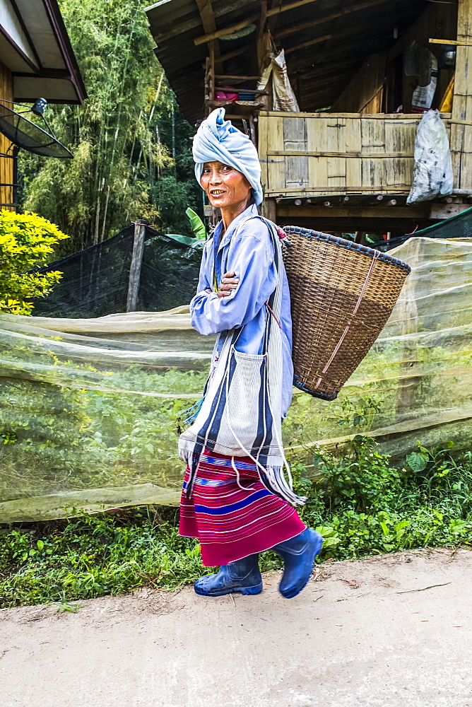 Young woman from the Karen tribe wearing traditional garments in a village, Thailand