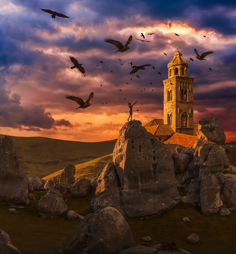 Crows flying towards a church tower with a wooden human mannequin laying on the ground in the foreground