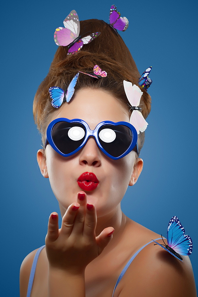 Glamour shot of girl with butterflies on a blue background, Toronto, Ontario, Canada