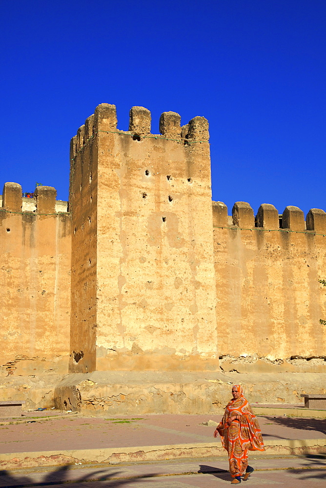 Woman in traditional dress with the Old City wall, Taroudant, Morocco, North Africa, Africa