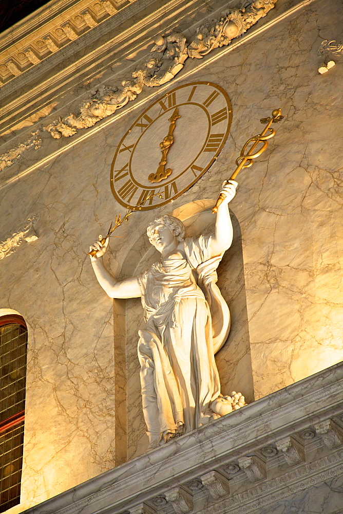 Clock and statue in Royal Palace, Amsterdam, Netherlands, Europe