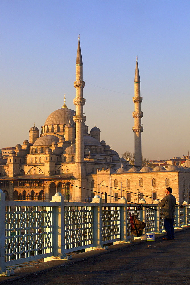 Fisherman on Galata Bridge with New Mosque in background, Istanbul, Turkey, Europe 