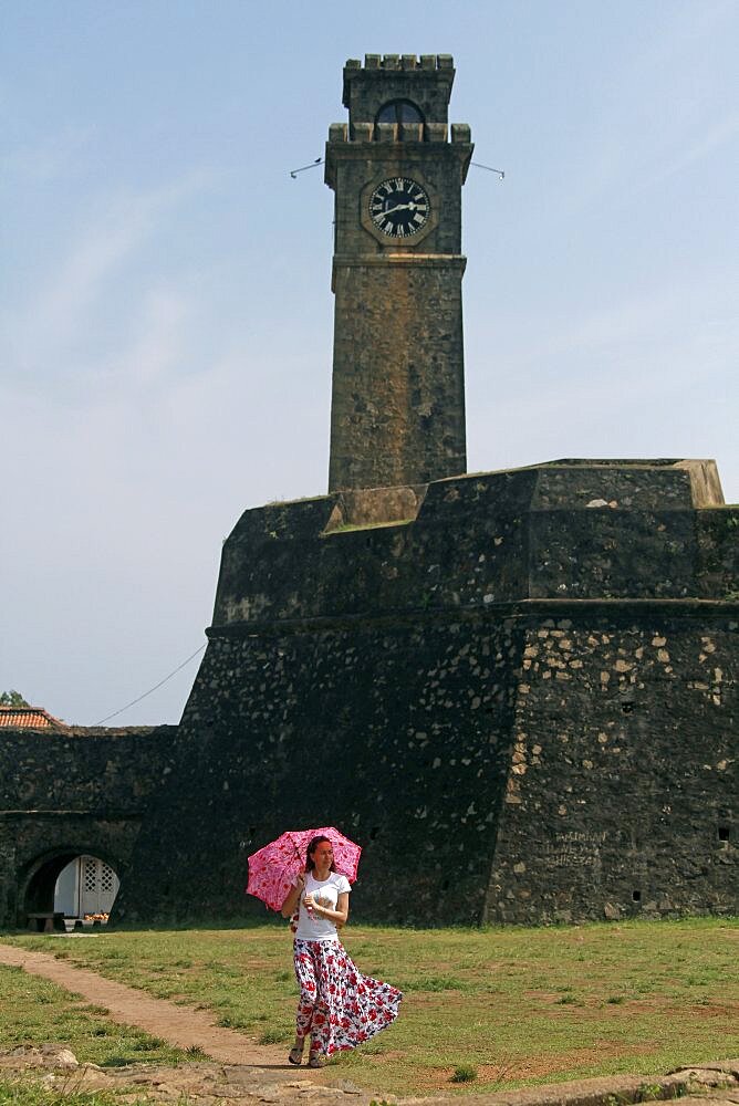 Lady with pink parasol at Clock Tower, Galle, Sri Lanka, Asia