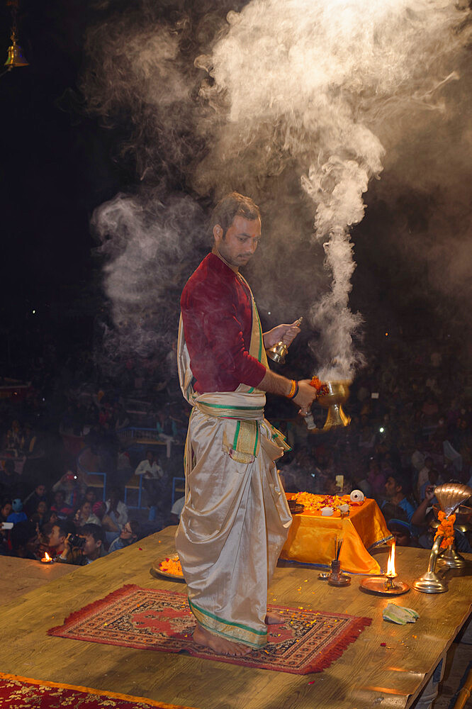 Priest celebrating the River Ganges, Aarti by offering incense, Dashashwamedh Ghat, Varanasi, Uttar Pradesh, India, Asia