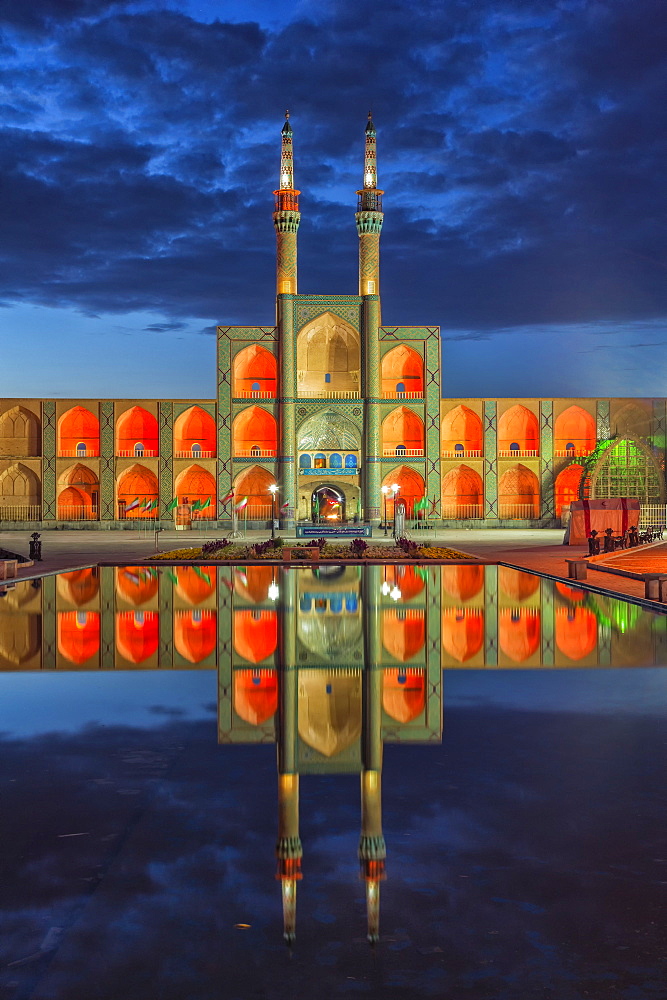 Amir Chaqmaq complex facade illuminated at sunrise and reflecting in a pond, Yazd, Yazd province, Iran, Middle East