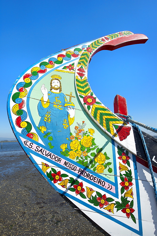 Colorful hand painted prow of a gondola-like moliceiro on the beach, Torreira, Aveiro, Beira, Portugal, Europe