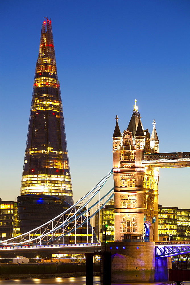 The Shard building and Tower Bridge at Night, London, United Kingdom.  The Shard is the tallest building in Europe (2012).