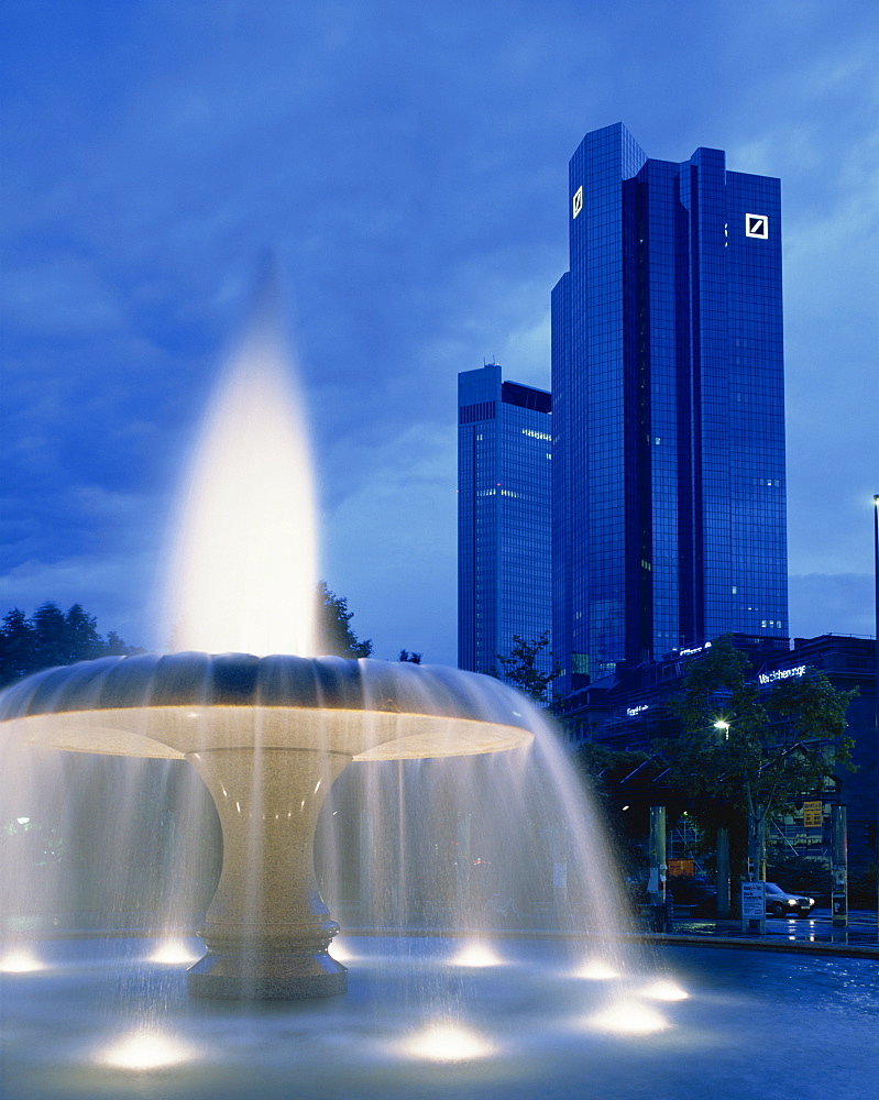 The Deutsche Bank with water fountain illuminated at dusk, Frankfurt am Main, Germany, Europe