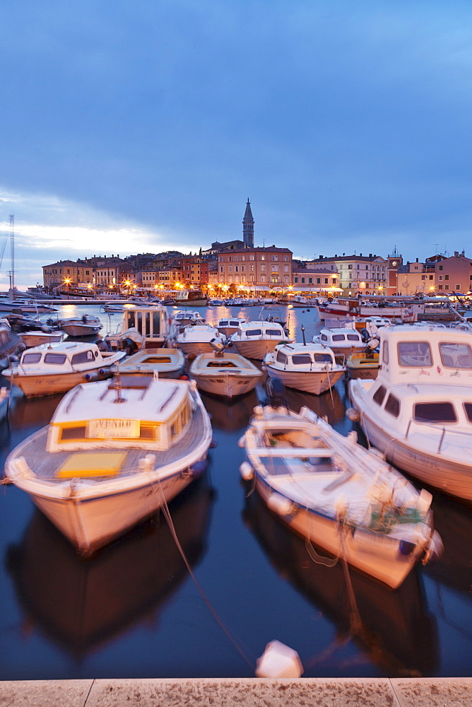 Ships and boats in the harbour and the old town with cathedral of St. Euphemia at dusk, Rovinj, Istria, Croatia, Europe