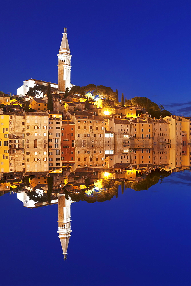 Old town with cathedral of St. Euphemia reflecting in the water at night, Istria, Croatia, Europe