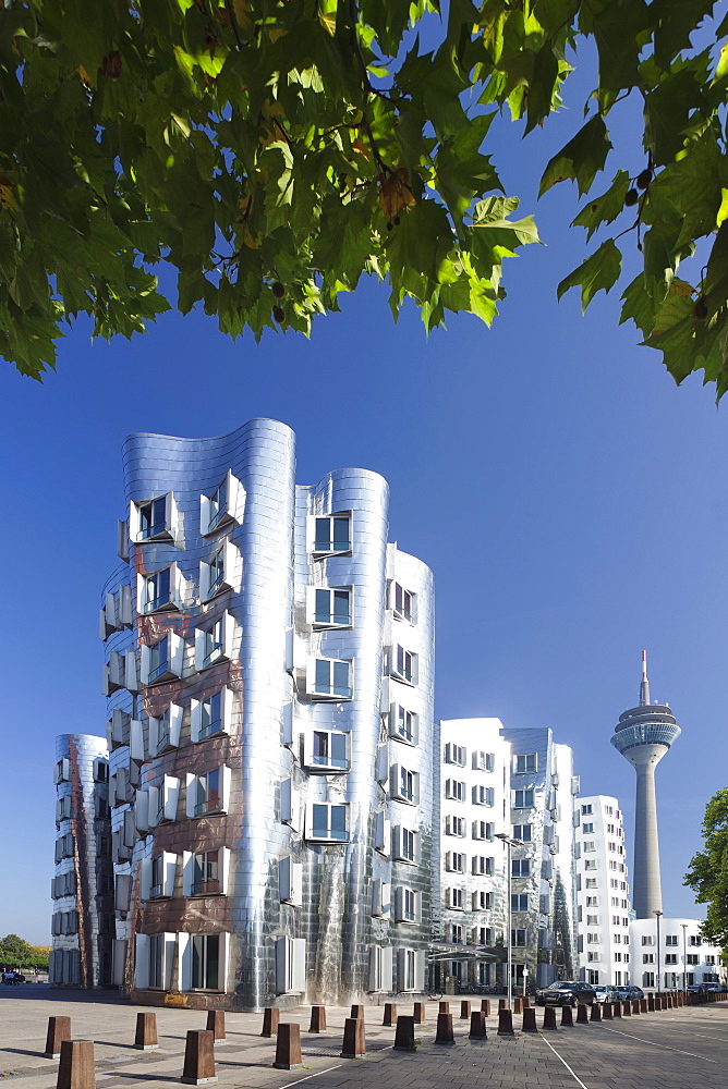 Neuer Zollhof, designed by Frank Gehry, and Rheinturm tower, Media Harbour (Medienhafen), Dusseldorf, North Rhine Westphalia, Germany, Europe 