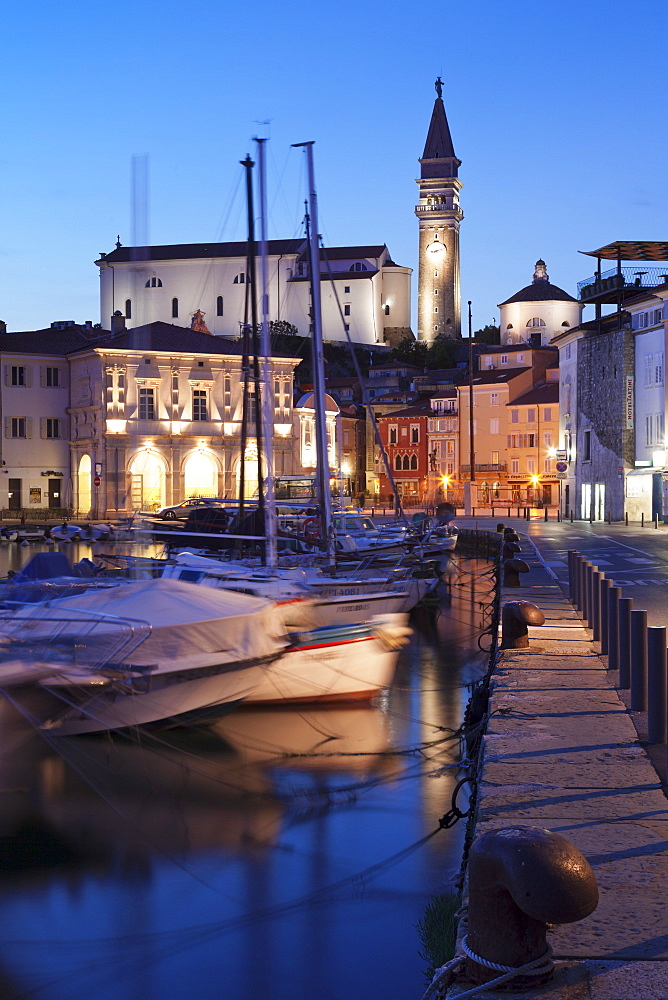 Waterfront buildings at the harbour and bell tower of Cathedral of St.George, Piran, Istria, Slovenia, Europe 