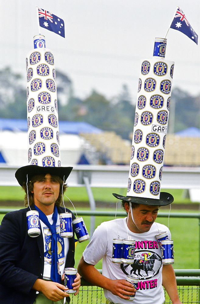 Supporters wearing oversized Fosters hats at the Melbourne Cup, Australia