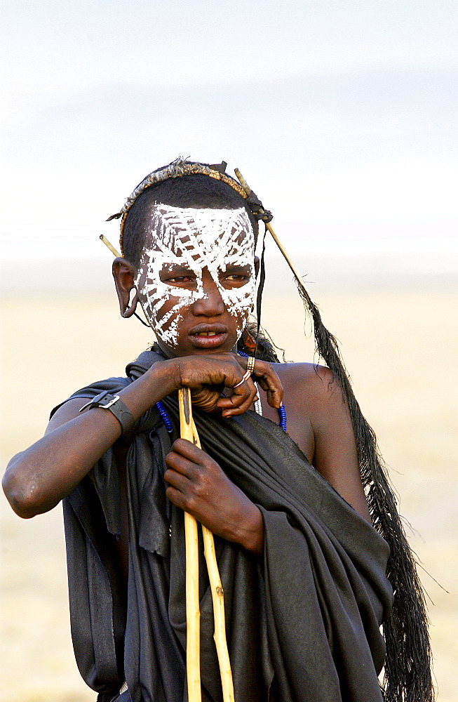 Young recently circumcised Masai Warrior (moran) with traditional face paint after 'coming of age'  in the Serengei Plains, Tanzania