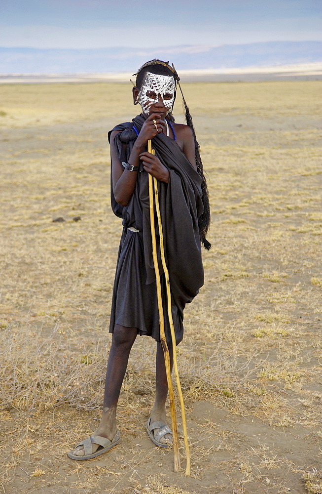 Young recently circumcised Masai Warrior (moran) with traditional face paint after 'coming of age'  in the Serengei Plains, Tanzania