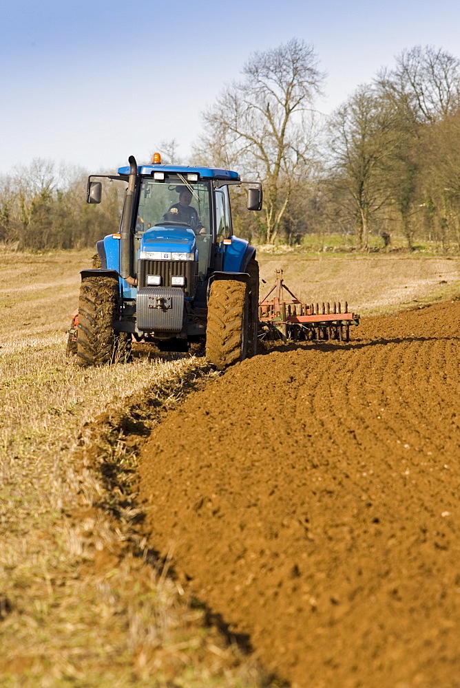 Tractor ploughing field in Oxfordshire, The Cotswolds, United Kingdom