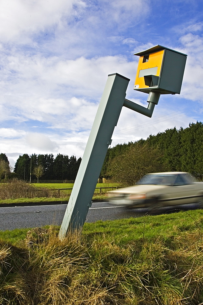 Traffic passes vandalised Gatso speed camera on A40, Oxfordshire, England, United Kingdom