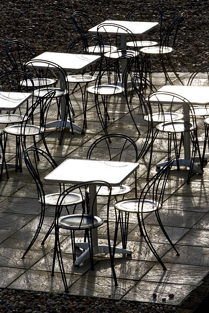 Deserted tables and chairs out of season on Brighton beach, South Coast,  England, United Kingdom