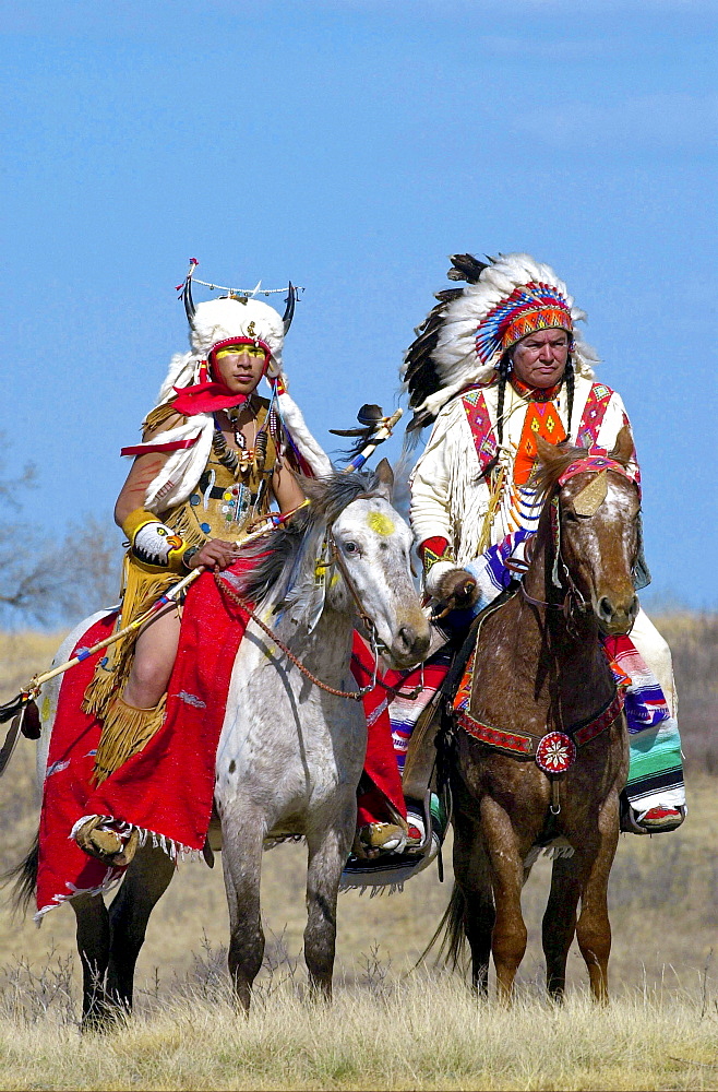 Canadian Plains Indians chiefs on horseback at cultural display at Wanuskewin Heritage Park in Saskatoon, Canada