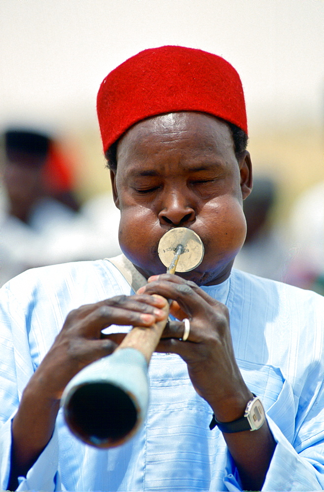 Musician playinga  traditional wind instrument, Nigeria