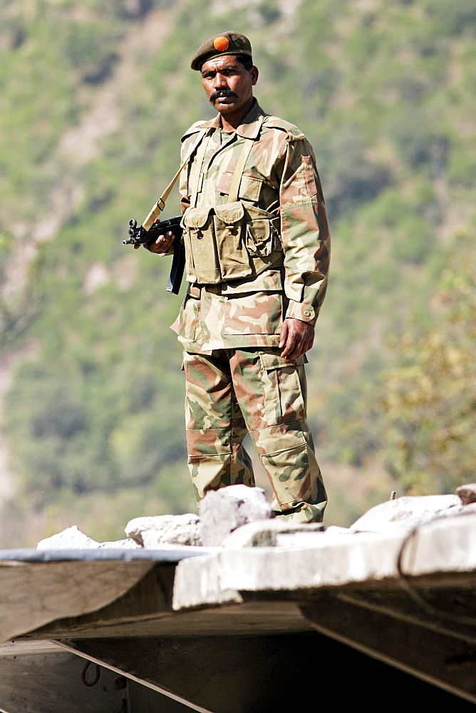 Armed Pakistani soldier on duty in village of Pattika, Pakistan