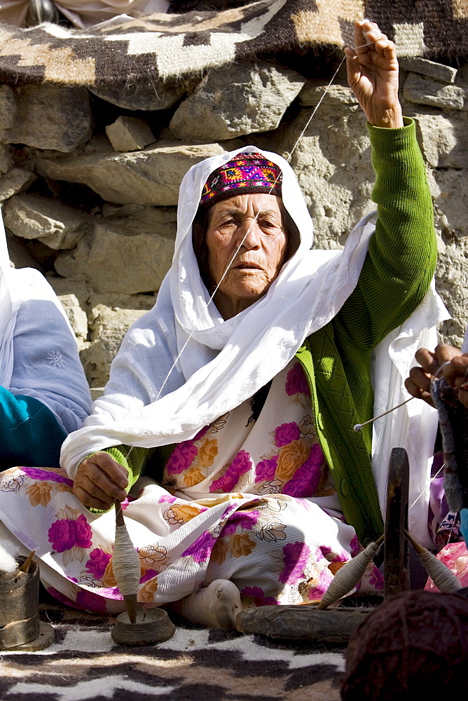 Woman spins wool in mountain village of Altit in Hunza region of Karokoram Mountains, Pakistan