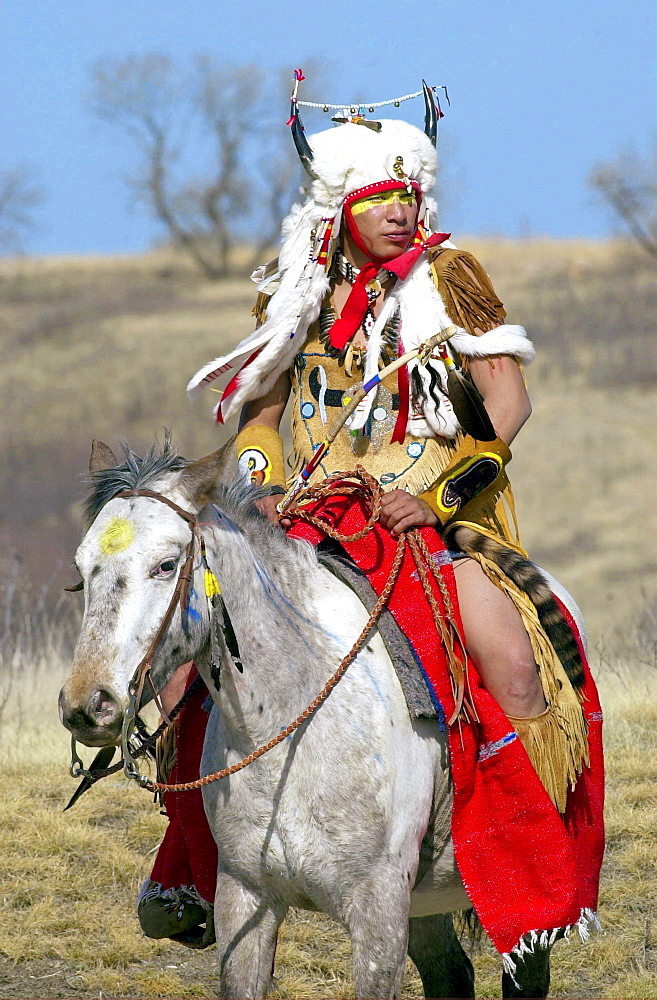 Canadian Plains Indians chief on horseback at cultural display at Wanuskewin Heritage Park in Saskatoon, Canada