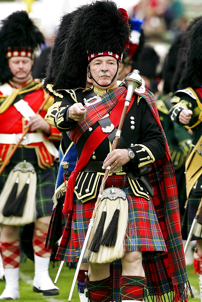 Drum Major leads massed band of Scottish pipers at the Braemar Games Highland Gathering