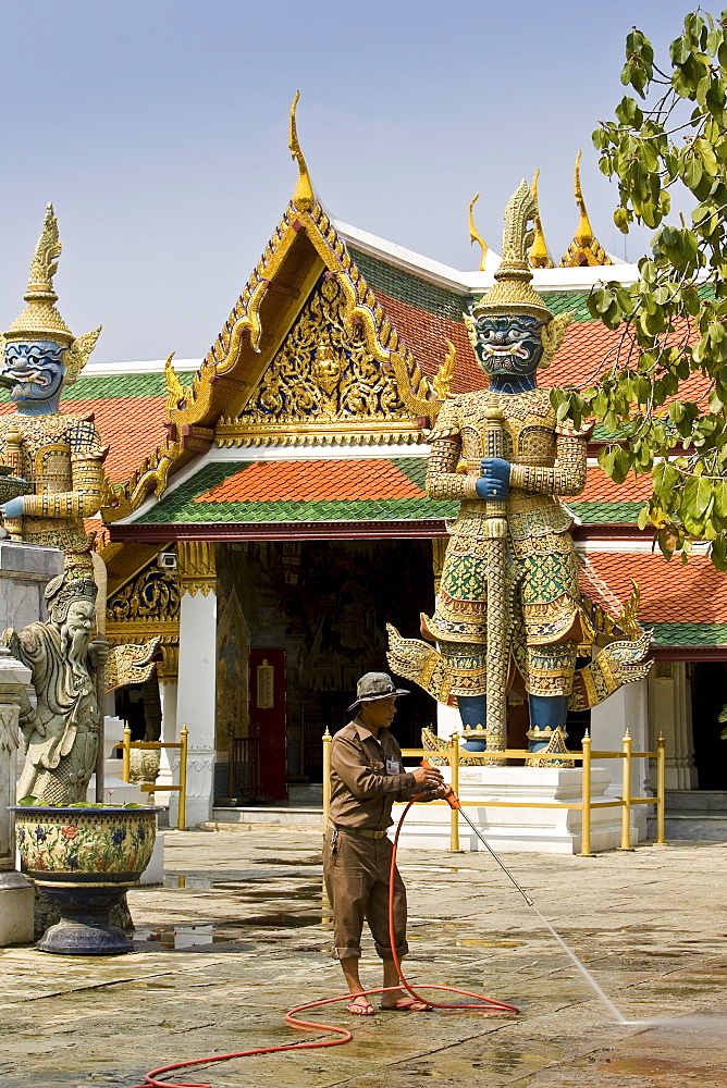 Man cleans inside The Grand Palace and Temple Complex, Bangkok, Thailand