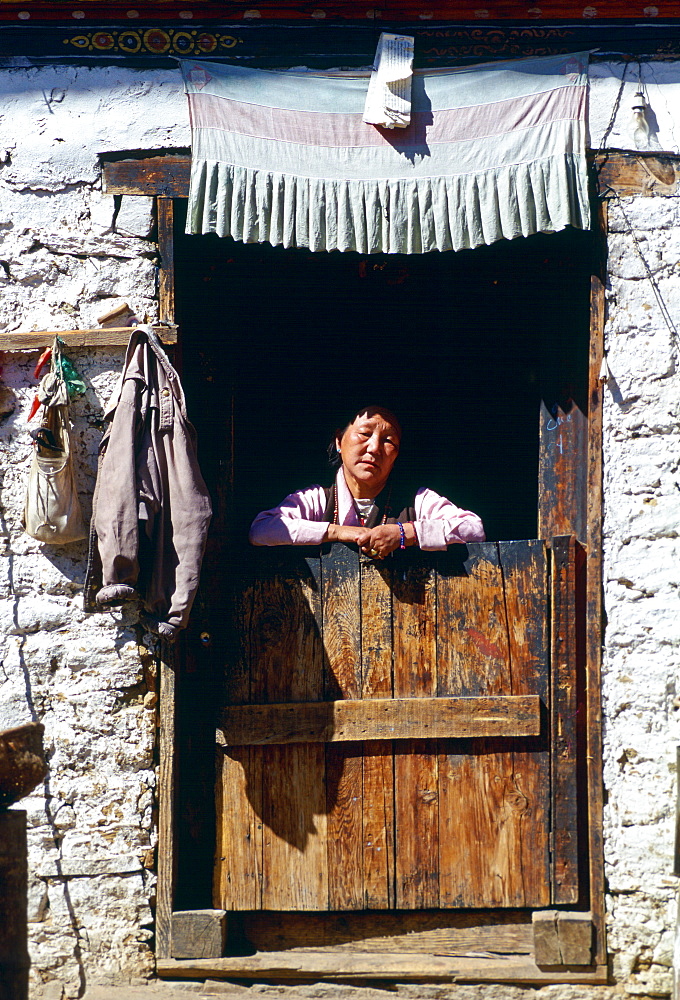 Woman at doorway of house, Paro, Bhutan