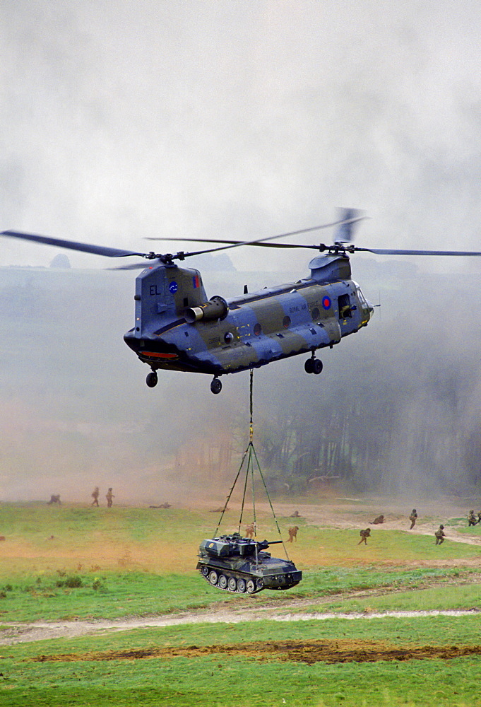 Chinook helicopter lifts a tank at display given by the 5th Airborne Brigade at Salisbury Plain, Wiltshire, UK