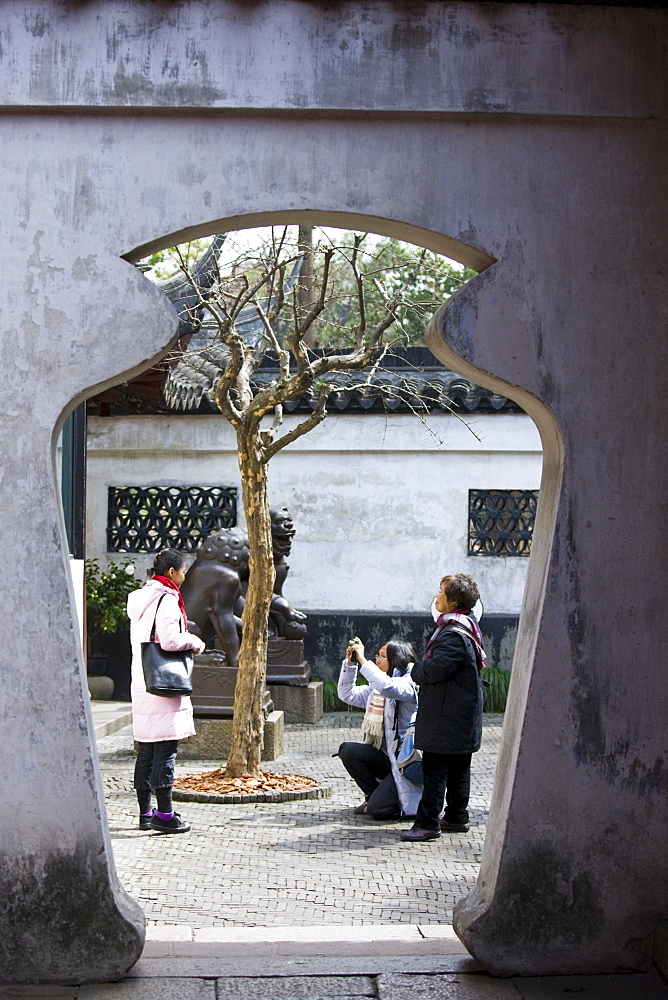 Visitors take photographs in the Yu Gardens, Shanghai, China