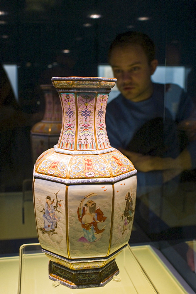 Visitor looks at Ming vase on display in the Shanghai Museum, China