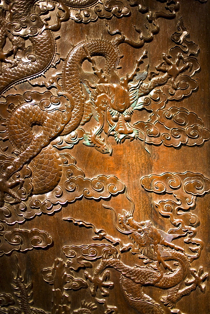 Qing Dynasty cabinet with engraved dragons and clouds design on display in the Shanghai Museum, China