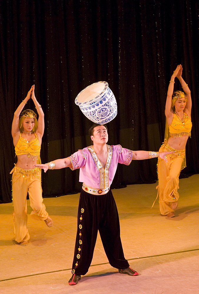 Members of the Shanghai Acrobatic Group performing on stage at the Shanghai Centre Theatre, China