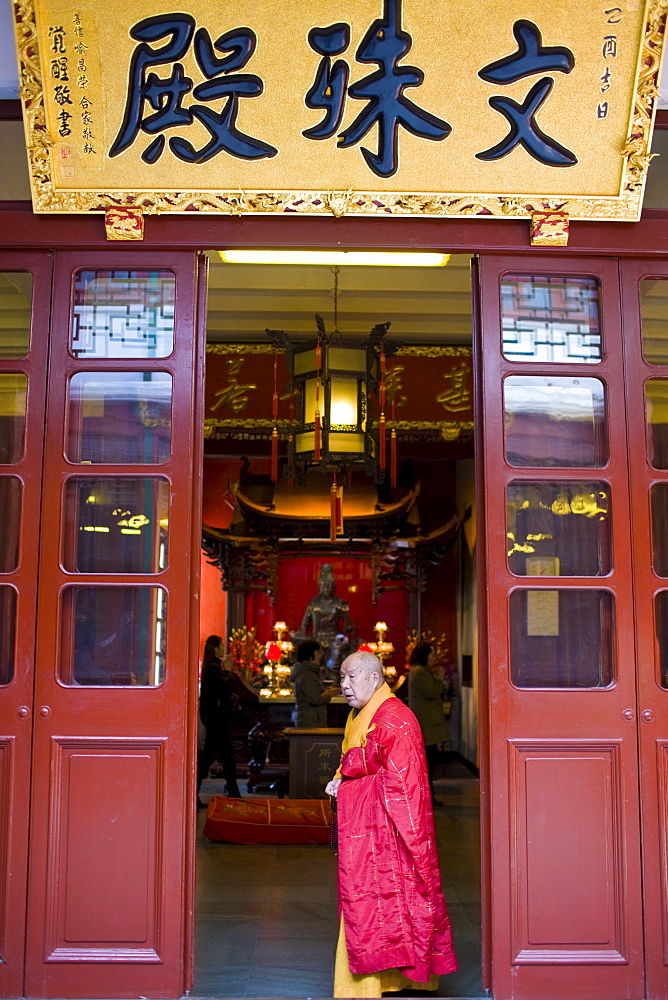 Buddhist monk takes part in religious ceremony at the Jade Buddha Temple, Shanghai, China