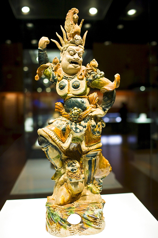 Figurine on display in glass case in the Shaanxi History Museum, Xian, China