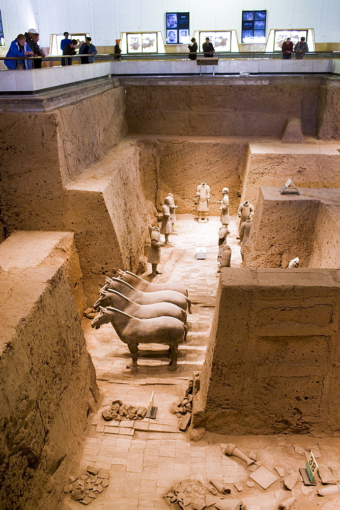 Tourists view Pit 3 containing horses and warriors as they were found, at Qin Museum of Terracotta Warriors, China