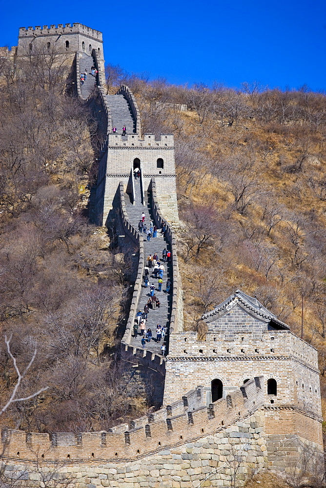 The ancient Great Wall of China snaking through mountains at Mutianyu, north of Beijing (formerly Peking)