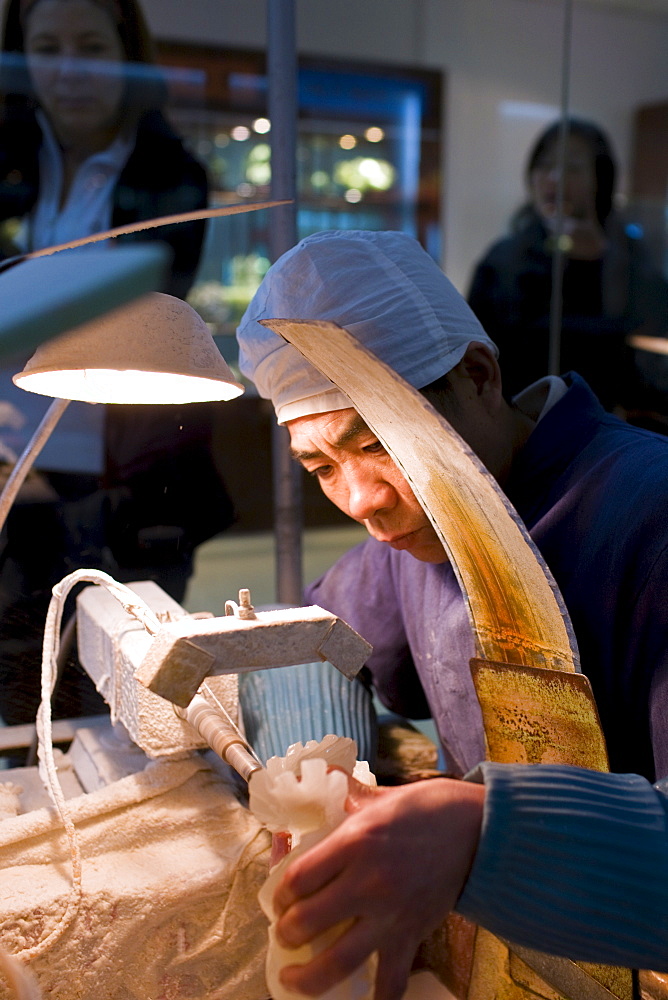 Jade craftsman at work in the Beijing Dragon Land factory in Beijing, China