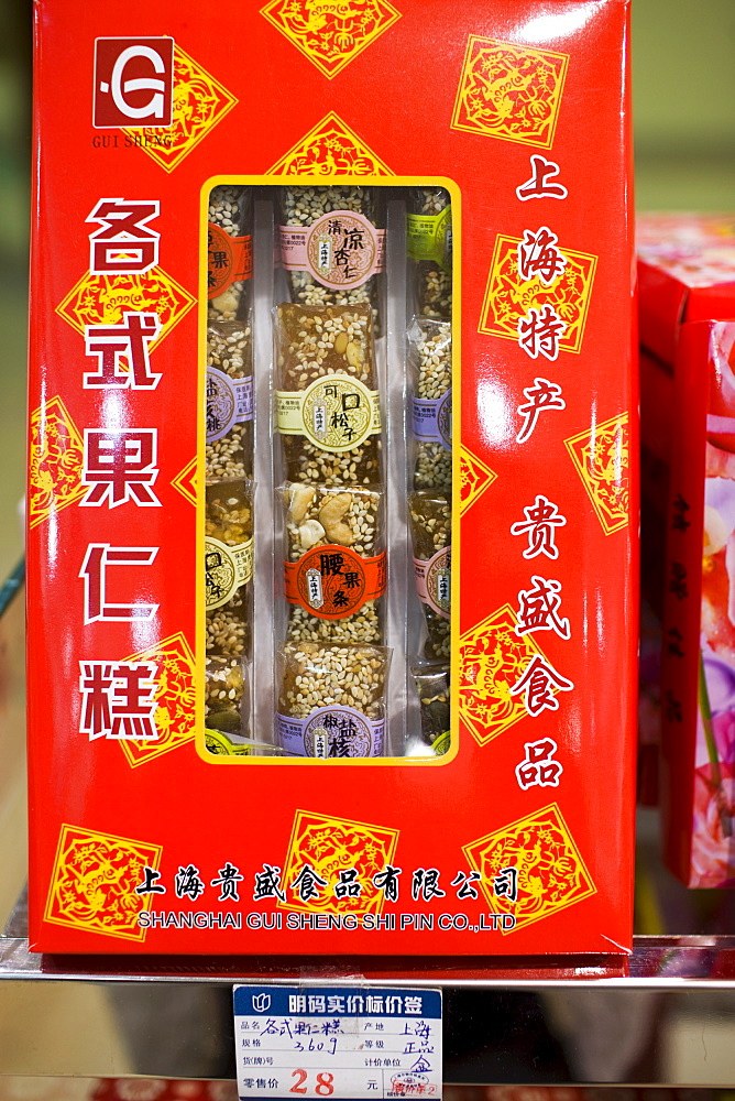 Box of Chinese sweets with nuts and sesame seeds on sale in souvenir shop, Shanghai, China